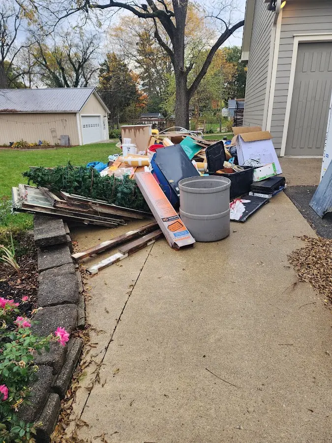 Dumpster being loaded with debris for Residential Dumpster Rental in Monroe